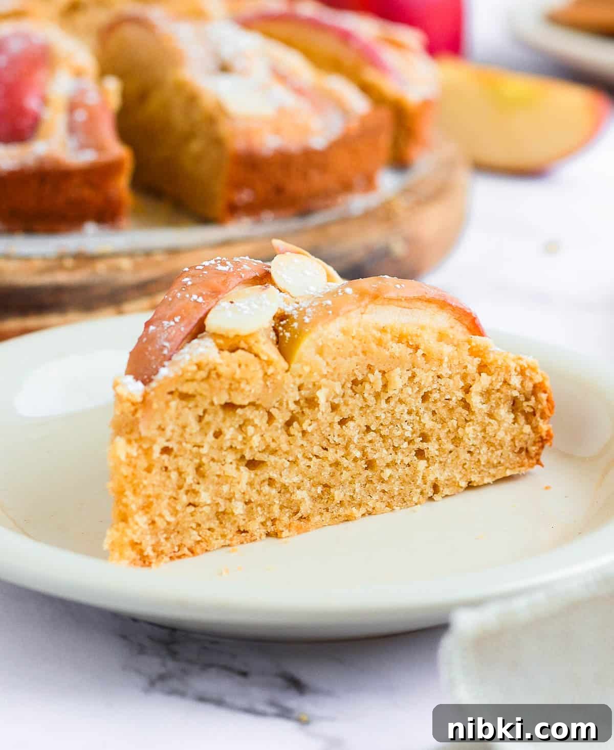 Moist Gluten-Free Apple Cake Recipe 5 One slice of cake on a small white plate.