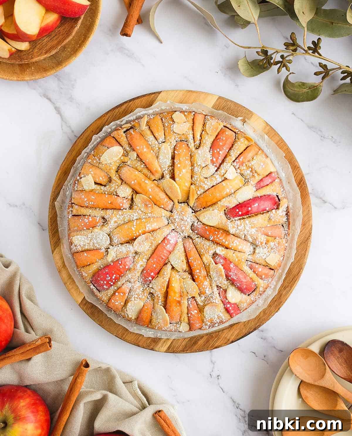Moist Gluten-Free Apple Cake Recipe 6 Apple Cake from above surrounded by apples, leaves and plates.