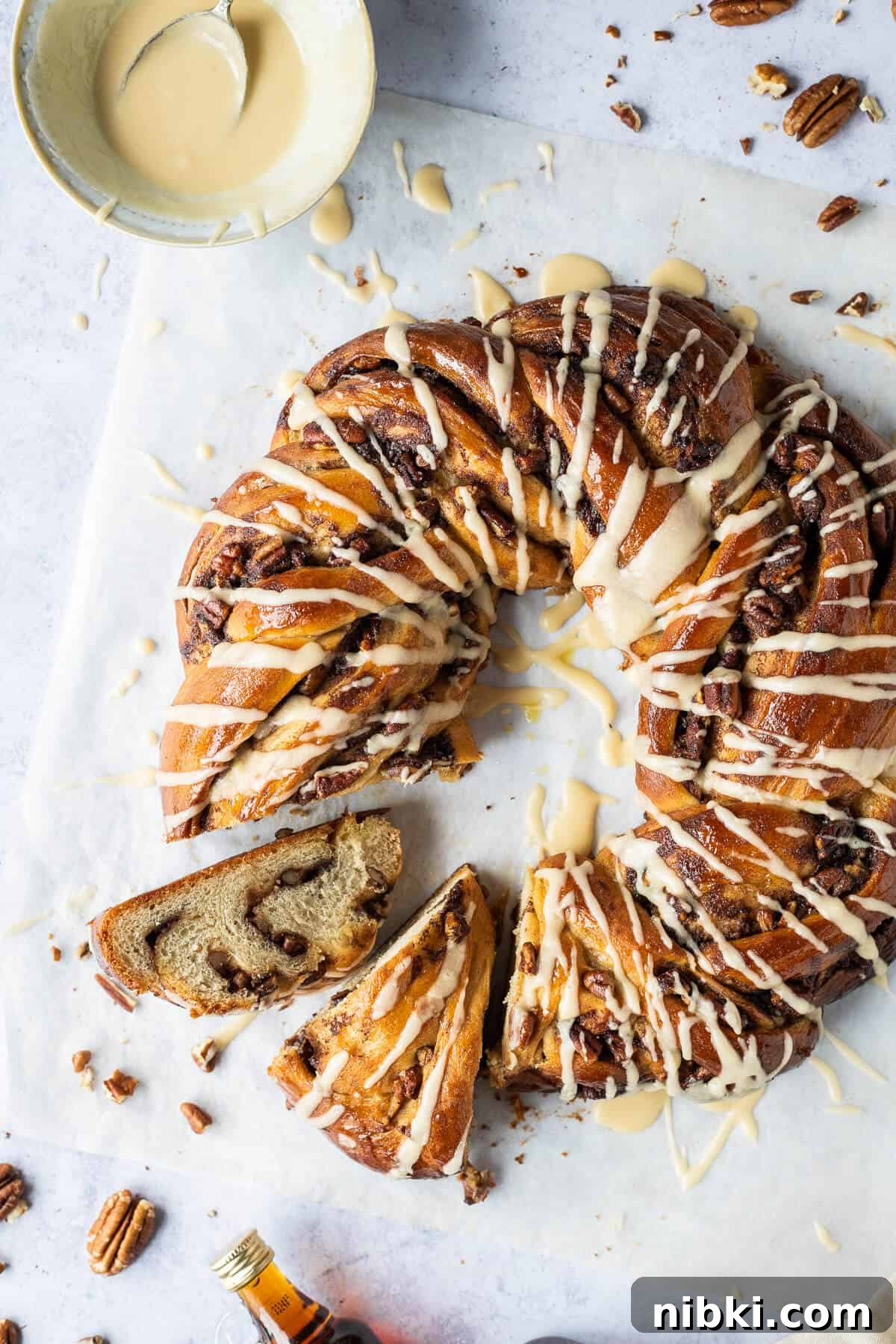 Close up of vegan maple pecan bread wreath with two slices cut out.