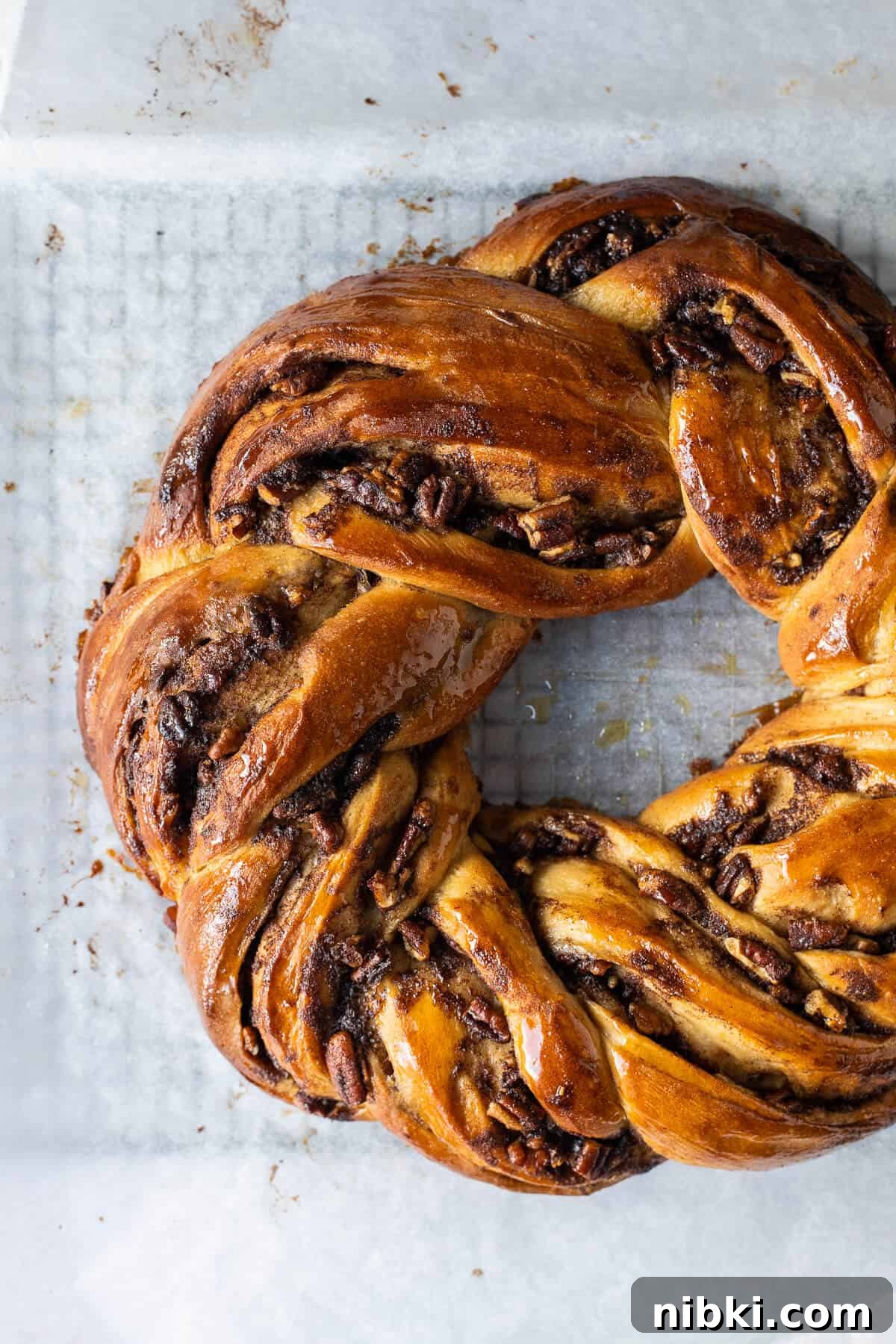 Close up of an unglazed loaf of maple pecan couronne.