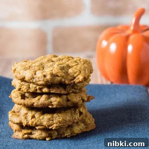 These chewy pumpkin oatmeal cookies are flavored with spices and nutty browned butter, and are loaded with caramel chips. #PumpkinWeek
