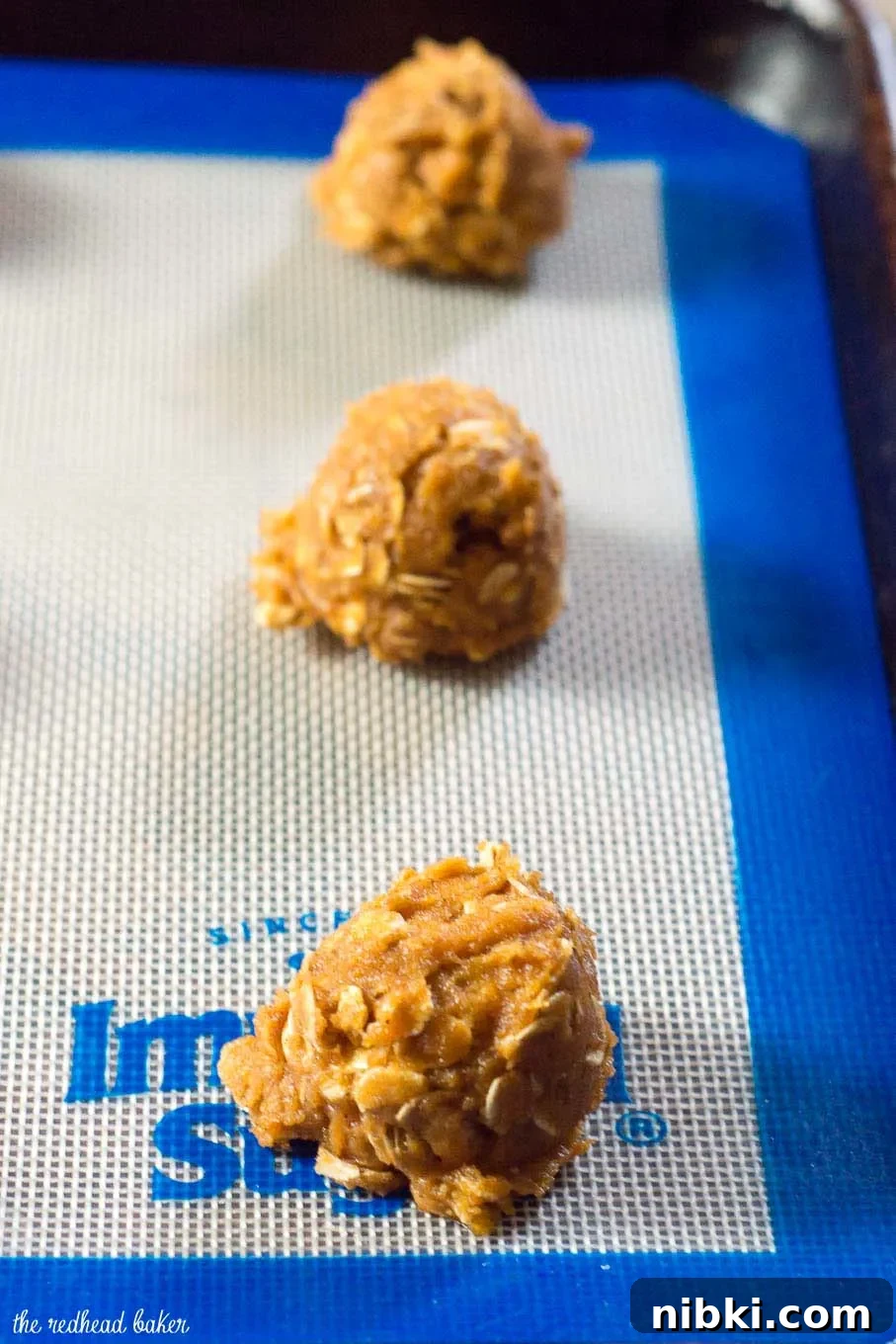 These chewy pumpkin oatmeal cookies are flavored with spices and nutty browned butter, and are loaded with caramel chips. #PumpkinWeek