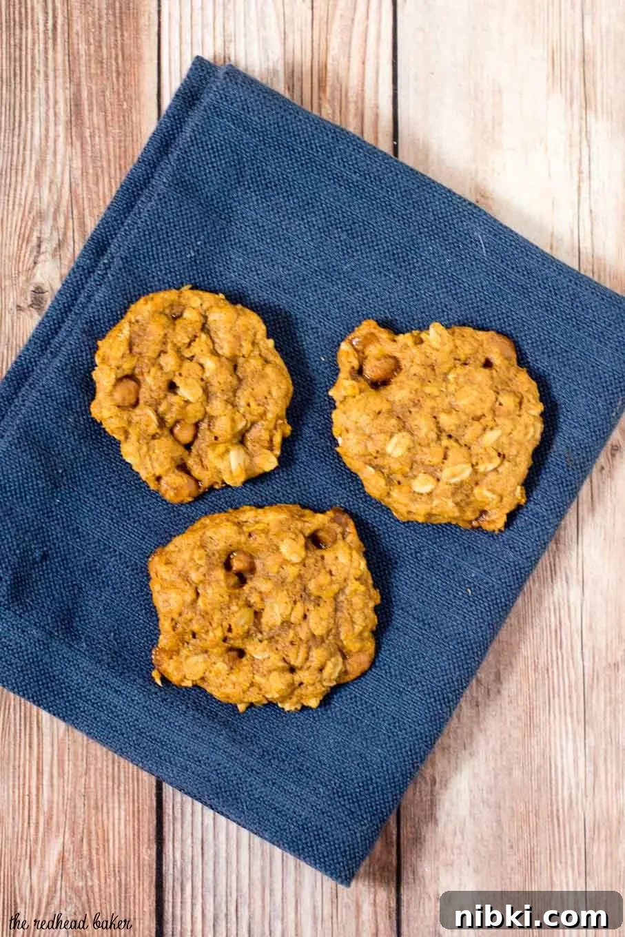 These chewy pumpkin oatmeal cookies are flavored with spices and nutty browned butter, and are loaded with caramel chips. #PumpkinWeek