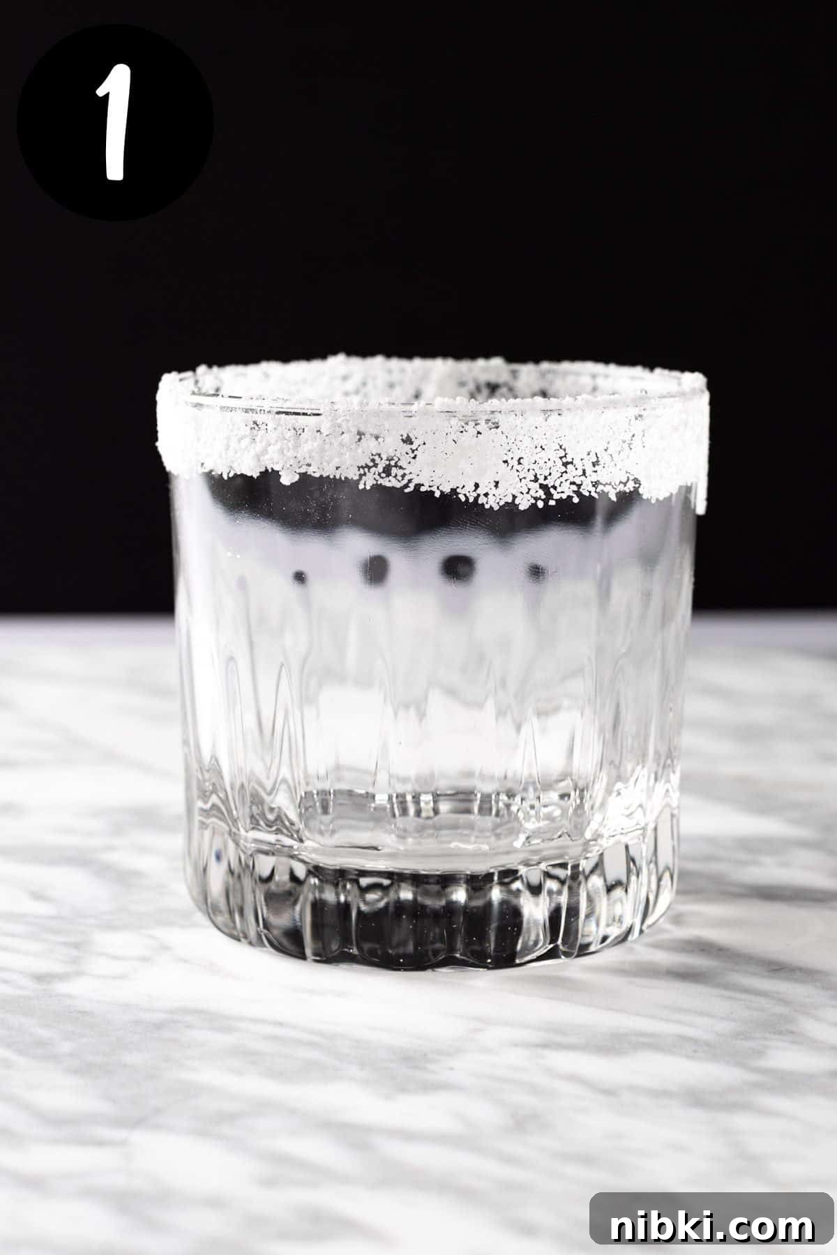 A cocktail glass with a sugar rim.