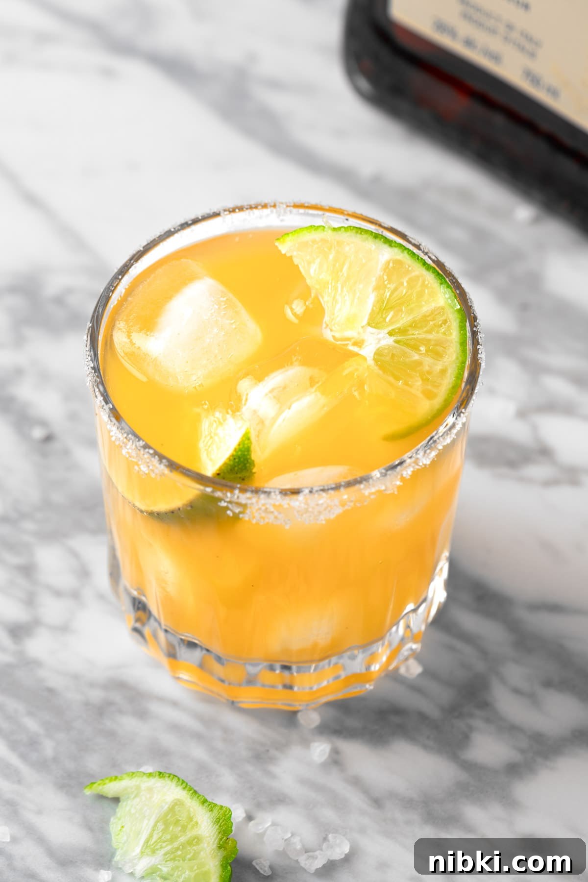 An Italian Margarita garnished with lime and a sugar rim.