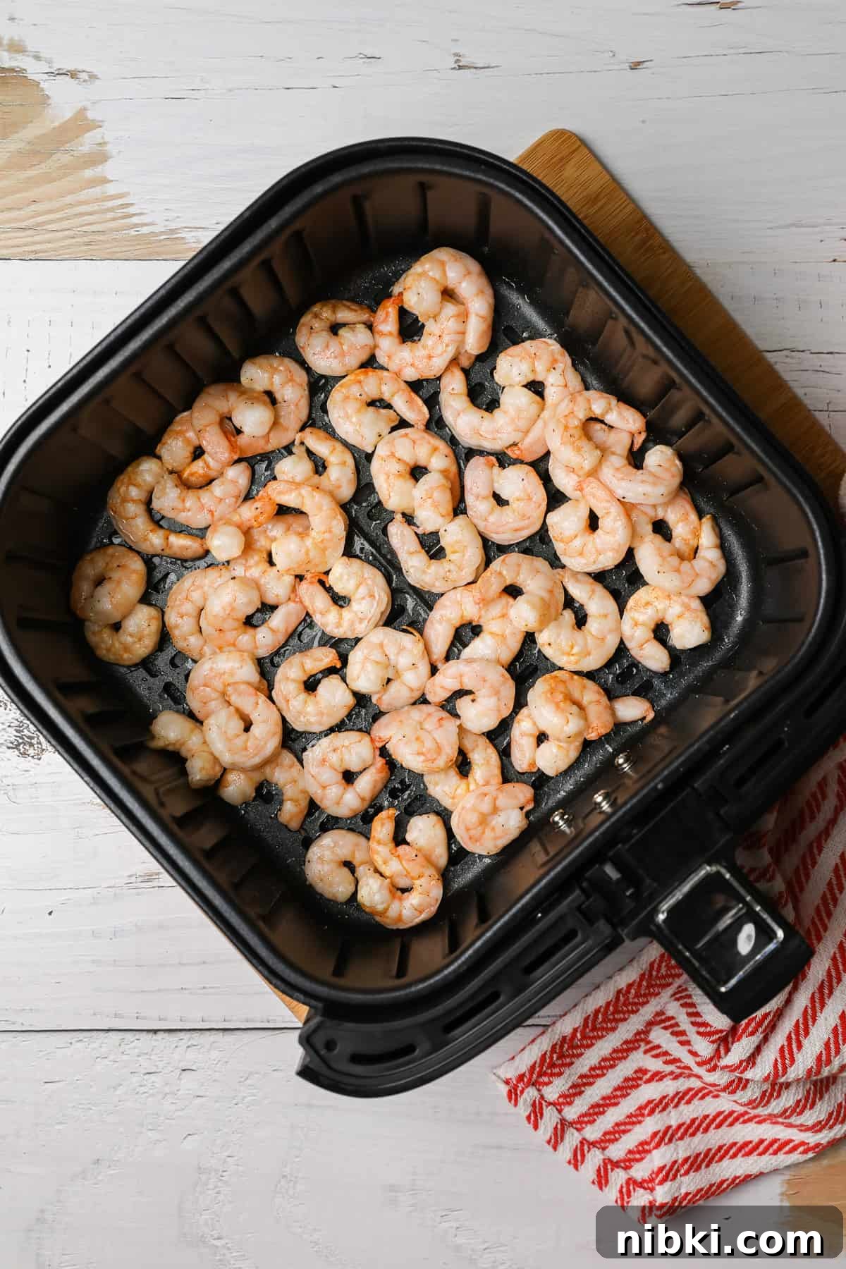 How to Cook Crispy Frozen Shrimp in the Air Fryer 5 cooked shrimp in an air fryer basket