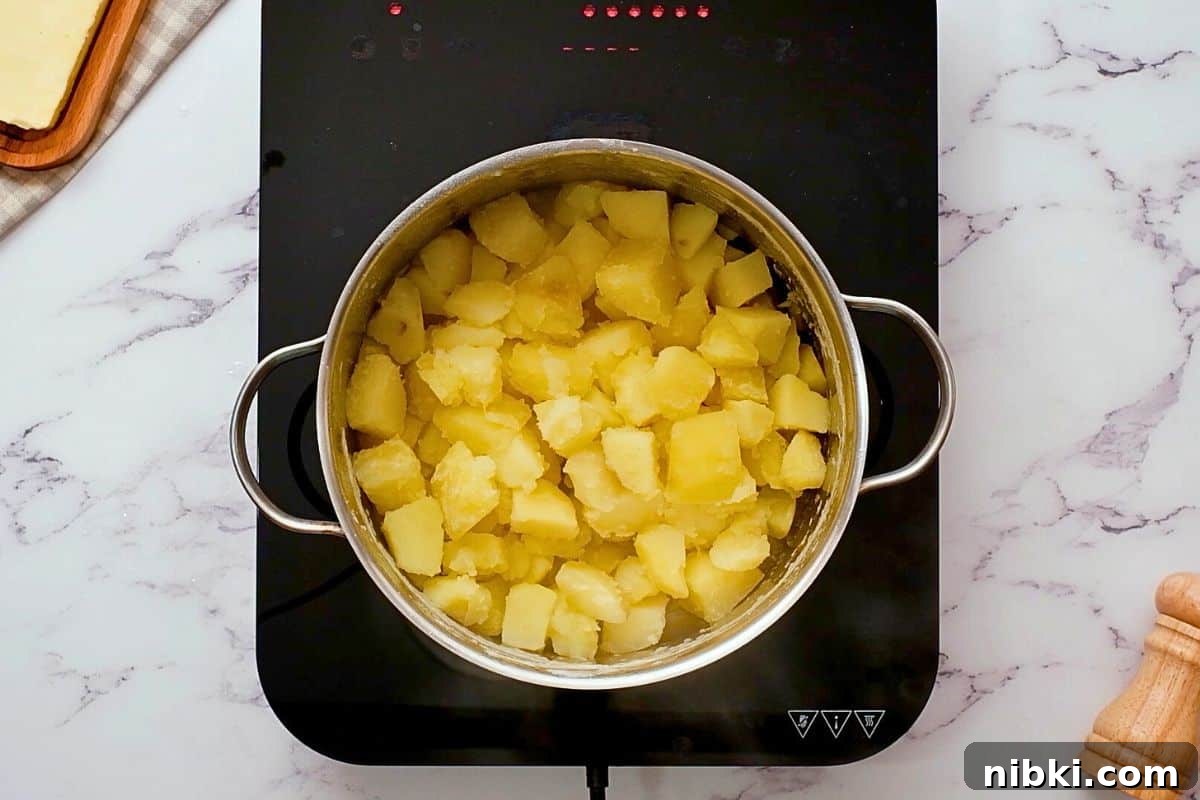 Mashed Potato Serving Size Cooked Yukon gold cubed potatoes in pan after being drained.