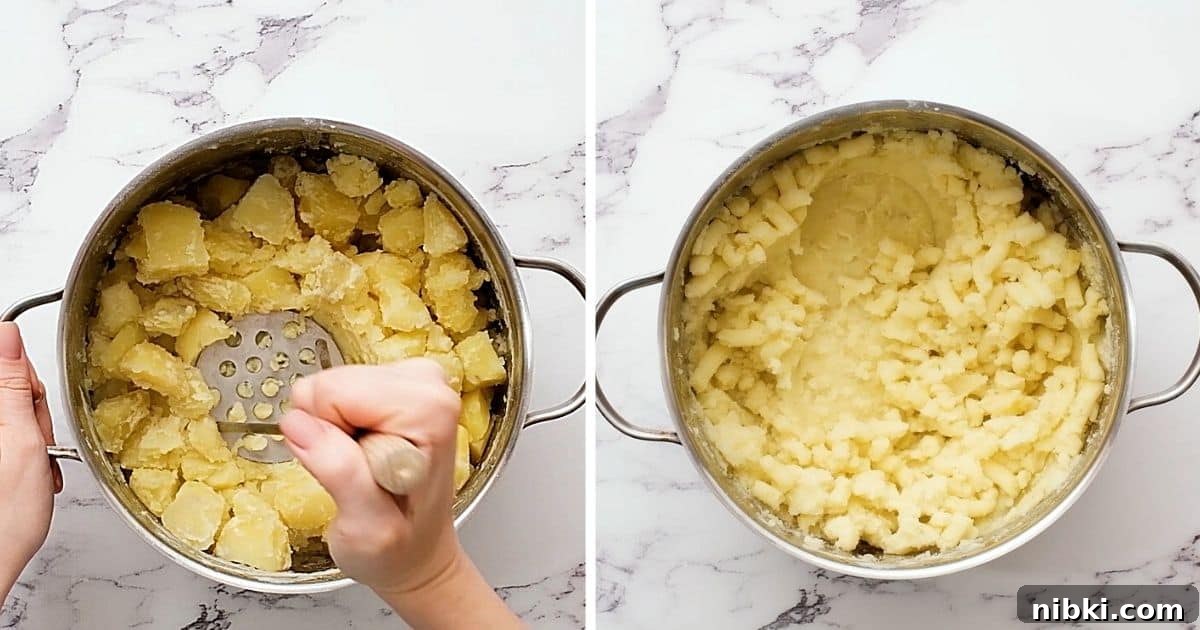 How to Mash Potatoes Handheld potato masher mashing cooked potatoes.