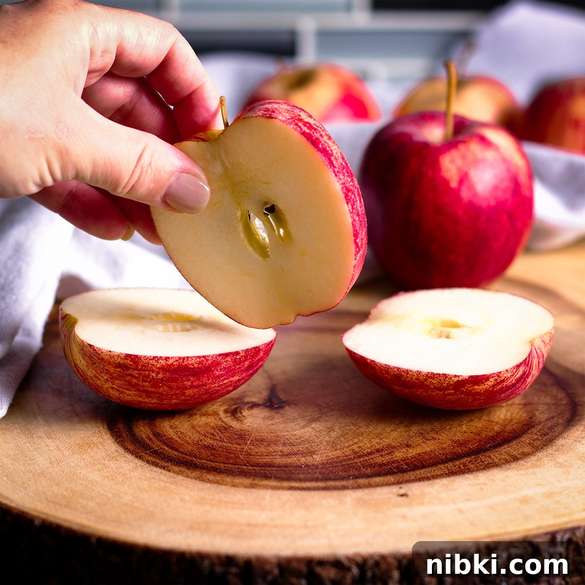 Spiced Apple Cider Cake with Cider Buttercream 10 Someone removing the core from an apple.