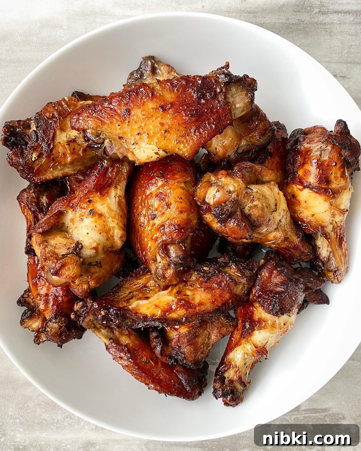 Crispy Marinated Chicken Wings in the Air Fryer 7 cooked marinated air fryer chicken in a white bowl