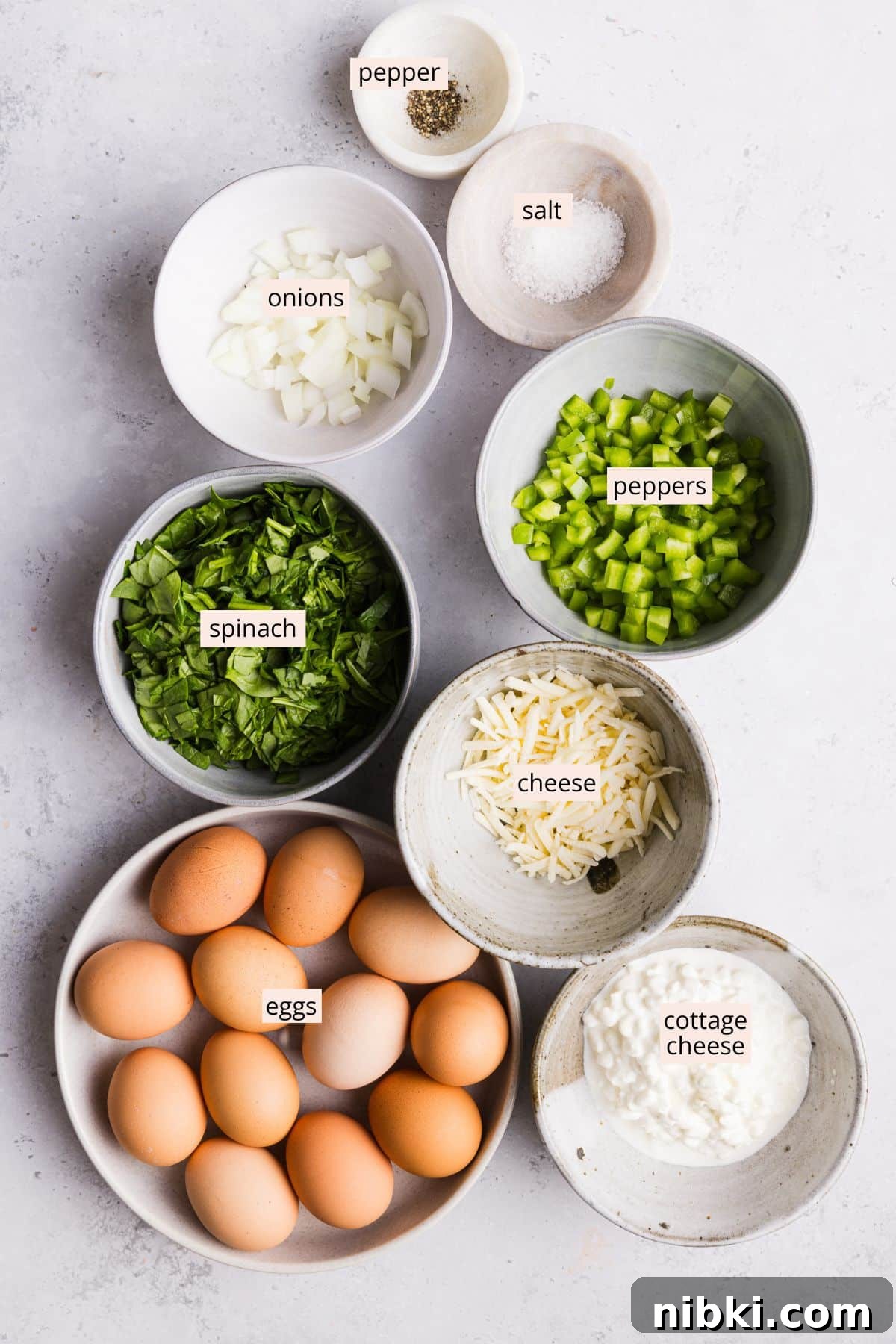 Ingredients for sheet pan eggs for sandwiches on a countertop with labels.