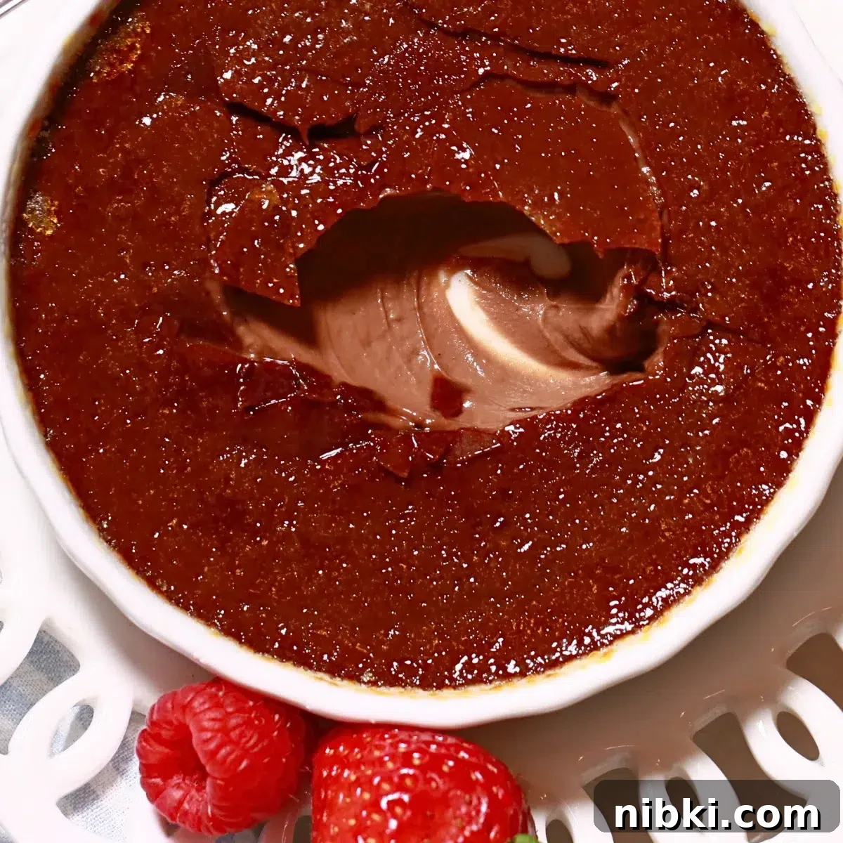 Silky Chocolate Crème Brûlée Recipe 2 homemade chocolate creme brulee assembled wth fresh berries on a white plate