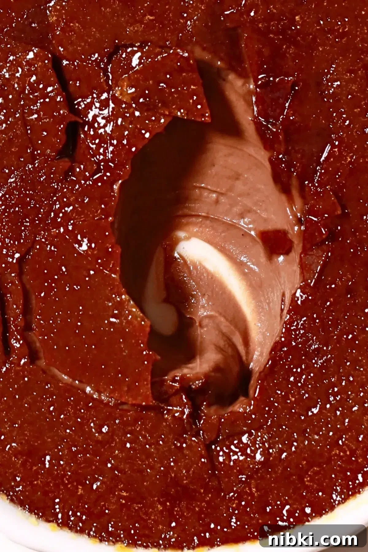 Silky Chocolate Crème Brûlée Recipe 3 dark chocolate creme brulee with a cracked caramel on the surface and a scooped filling