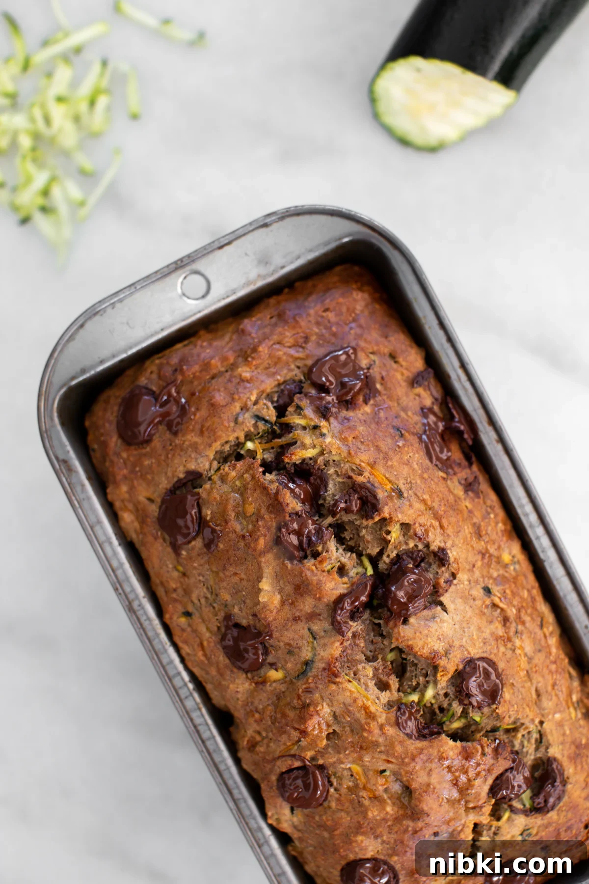 Sliced healthy zucchini banana bread with melted chocolate chips