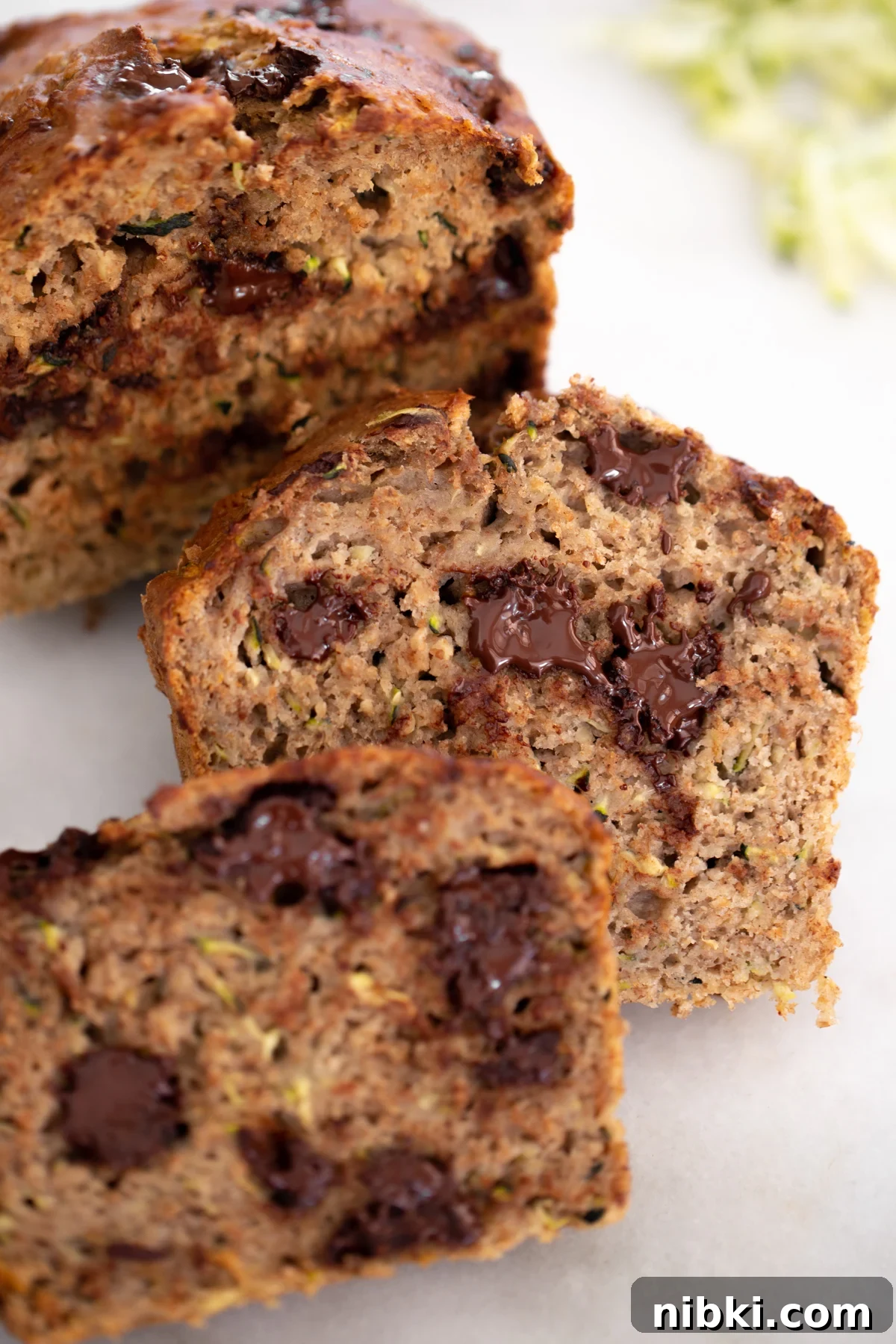 Closeup photo of sliced healthy zucchini banana bread with melted chocolate chips