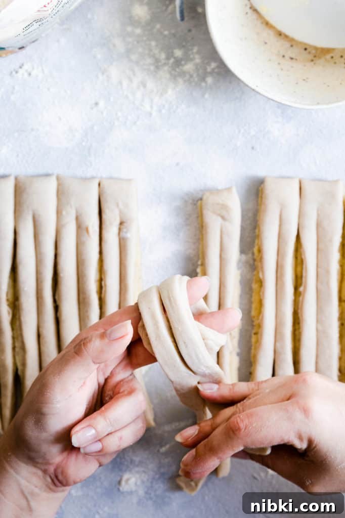 overhead shot of a person's hands shaping the dough into bun