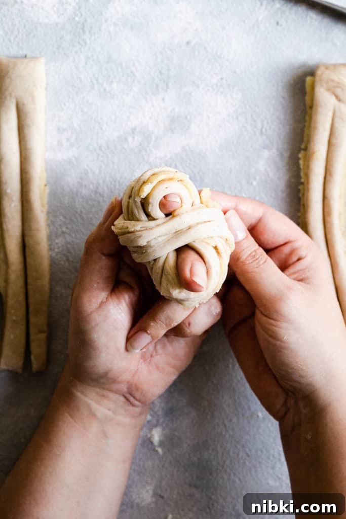top view of hands shaping the dough into knot