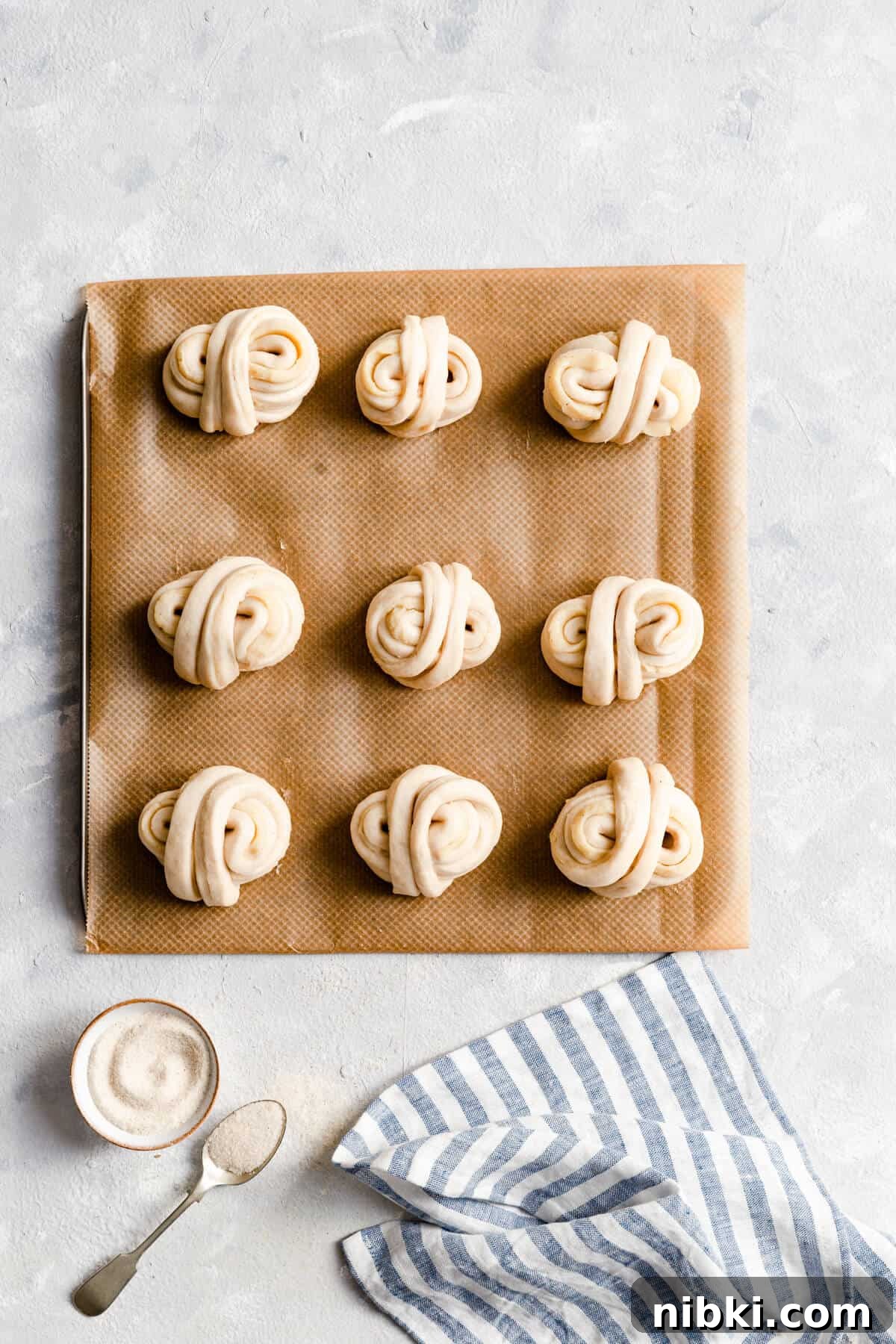 top view of unbaked cardamom buns on baking tray