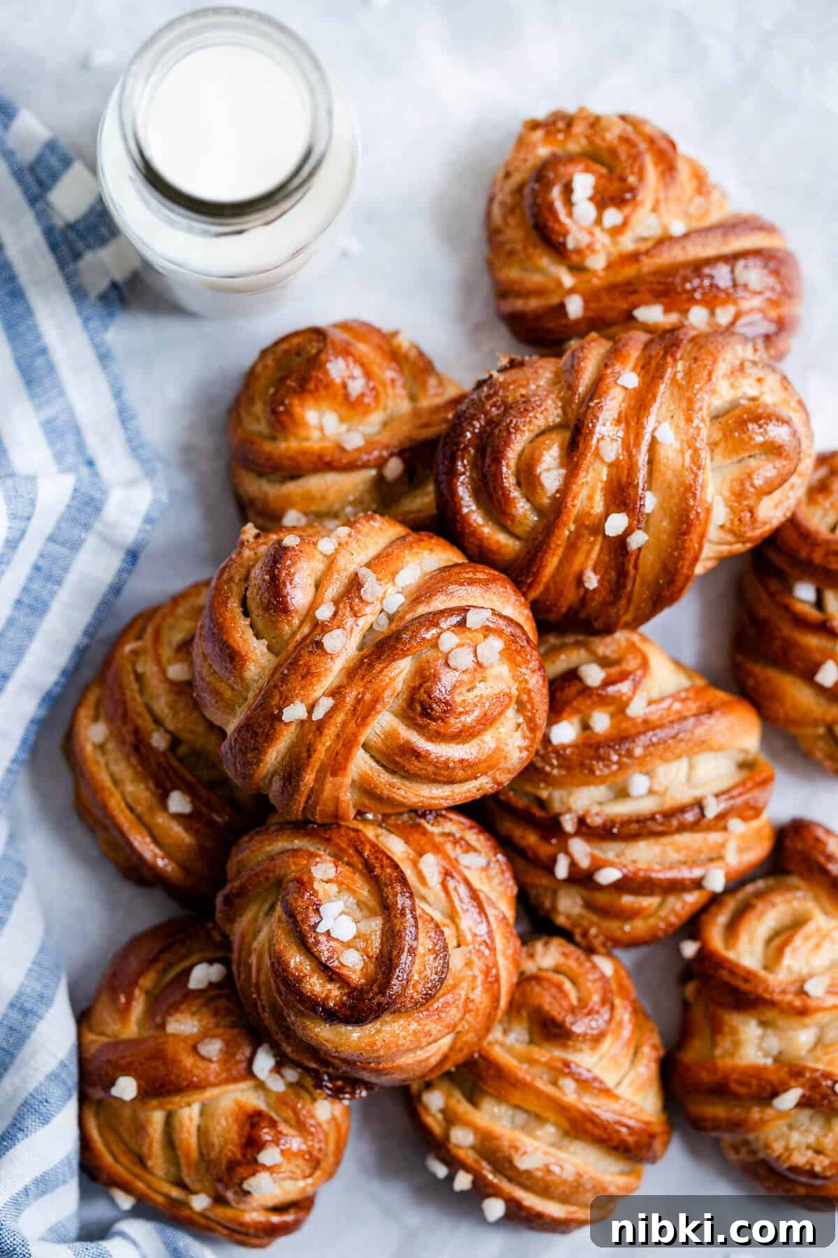 close up of cardamom buns topped with sugar pearls