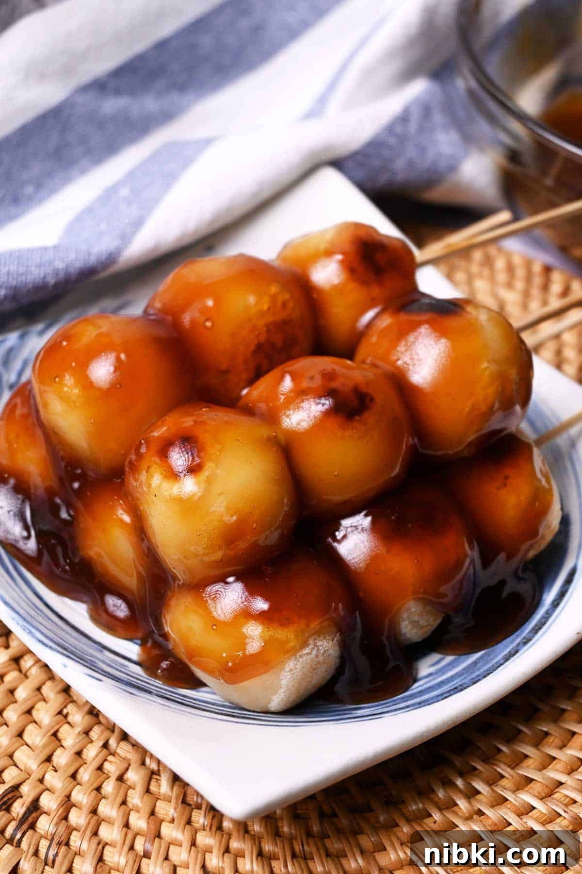 tofu mitarashi dango made with grilled tofu and sweet rice flour ball skewers and drizzled with sweet soy sauce glaze