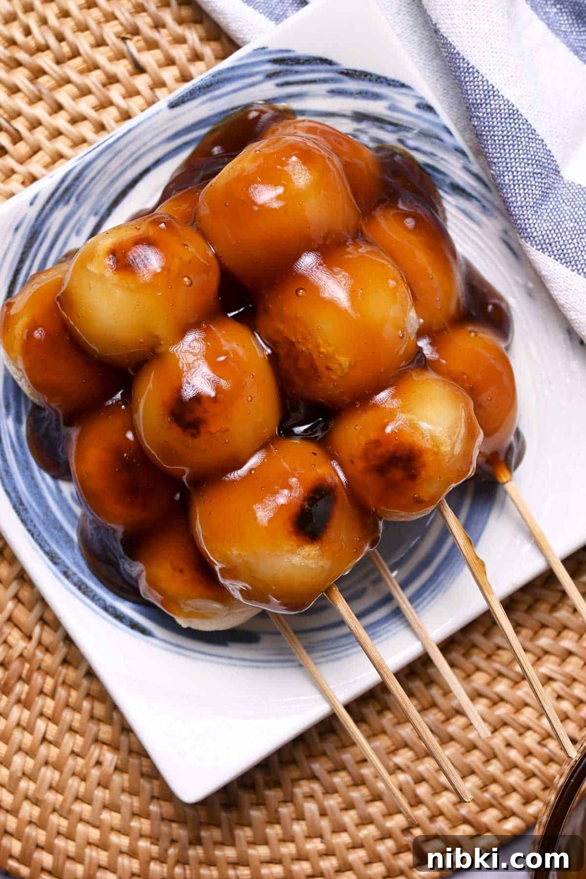 tofu mitarashi dango made with grilled tofu and sweet rice flour ball skewers and drizzled with sweet soy sauce glaze