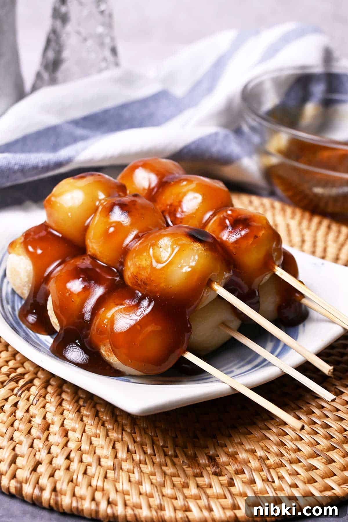 tofu mitarashi dango made with grilled tofu and sweet rice flour ball skewers and drizzled with sweet soy sauce glaze