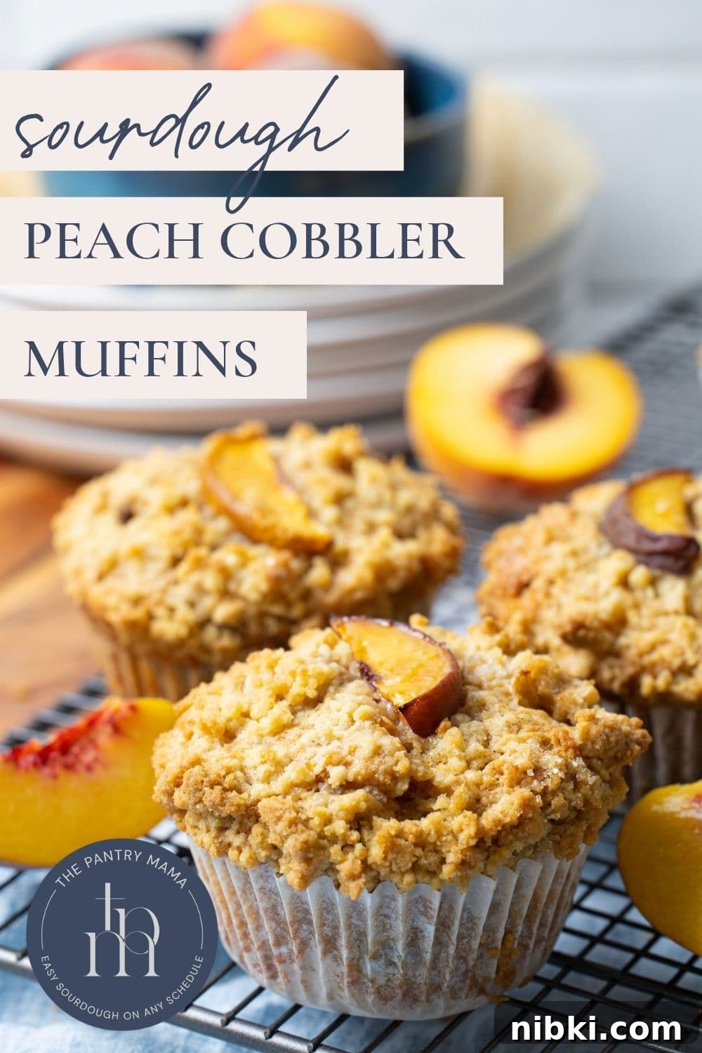 Sourdough Peach Cobbler Muffins Recipe 10 Close up image of sourdough peach cobbler muffins cooling on a wire rack with text overlay for a Pinterest Pin image.