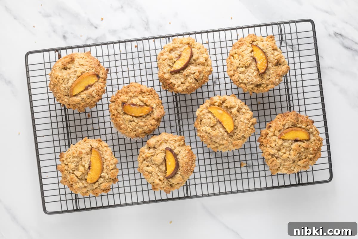 Sourdough Peach Cobbler Muffins Recipe 9 Fresh baked sourdough peach cobbler muffins cooling on a wire rack.
