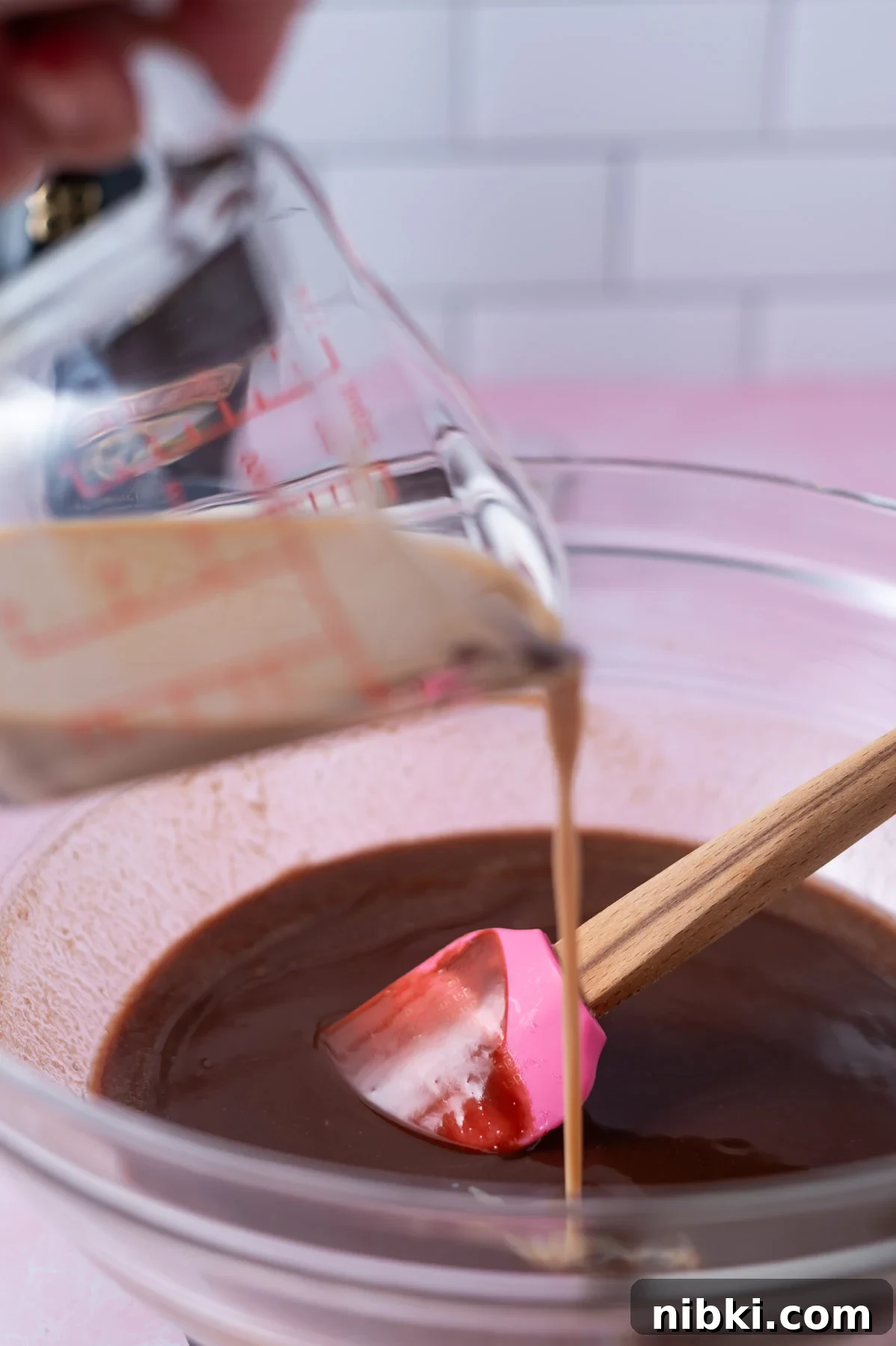 Fudgy Irish Cream Brownies Recipe 6 baileys being poured into melted chocolate and butter