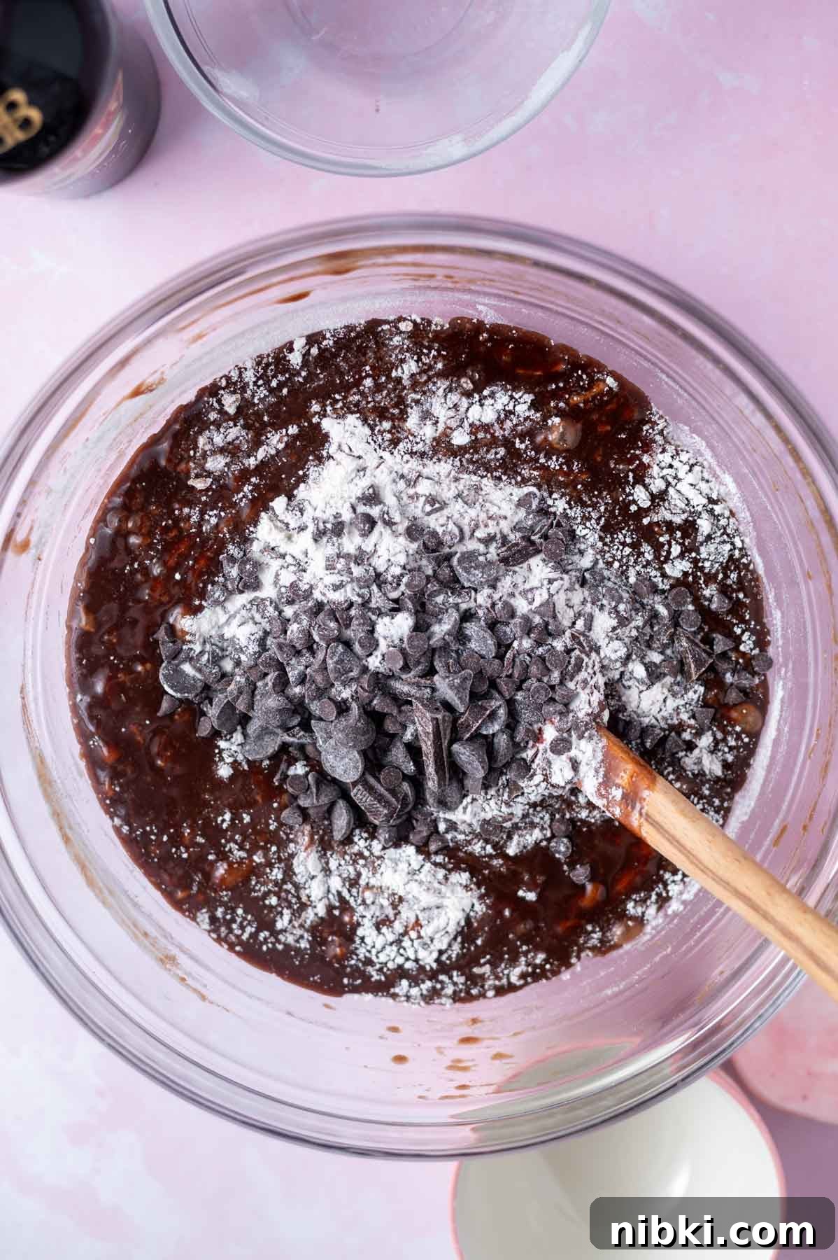 Fudgy Irish Cream Brownies Recipe 7 flour and chocolate chips being mixed into batter with a spatula
