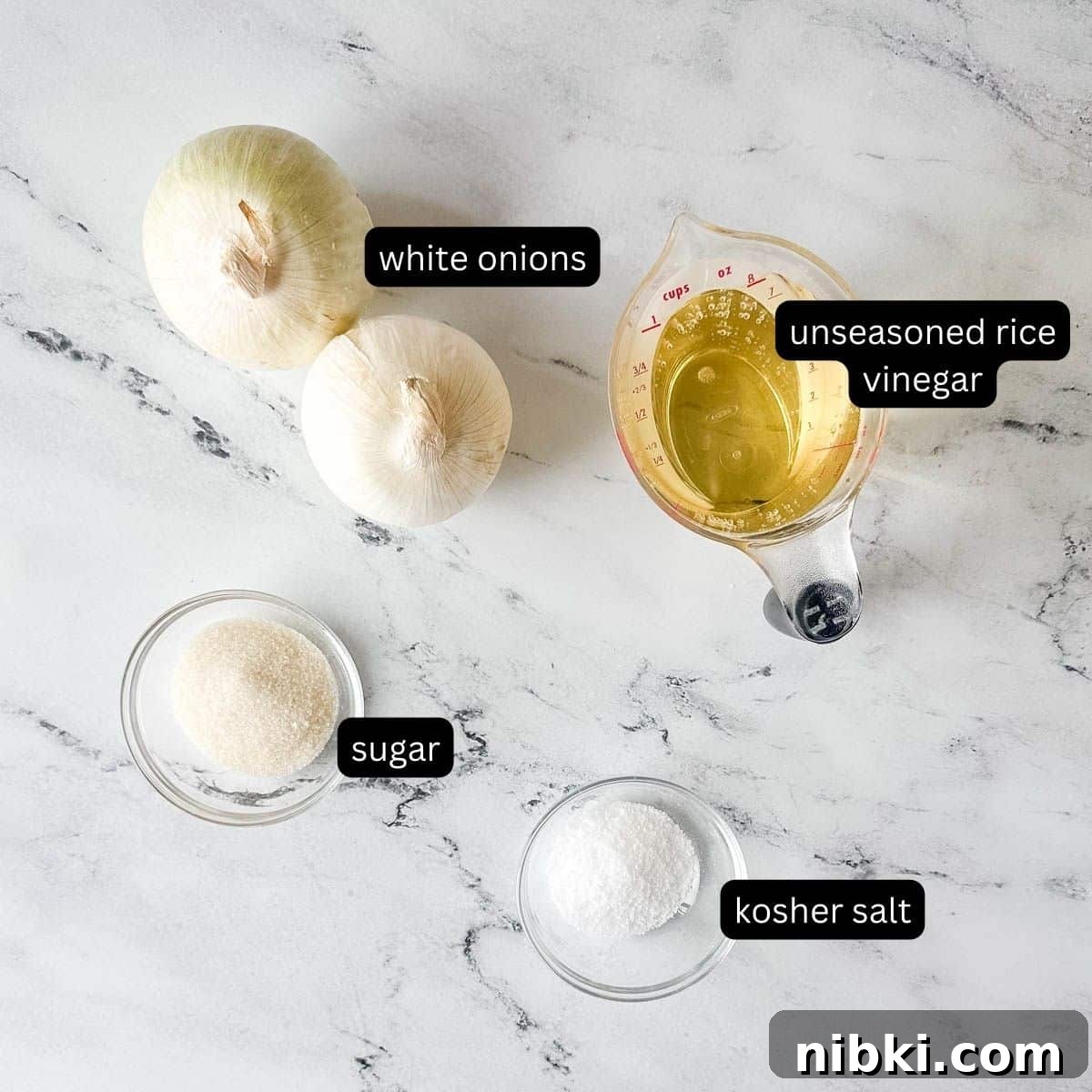 Quick Pickled White Onions for Tacos, Sandwiches and Salads 3 Labeled ingredients for pickled white onions on a white marble counter.