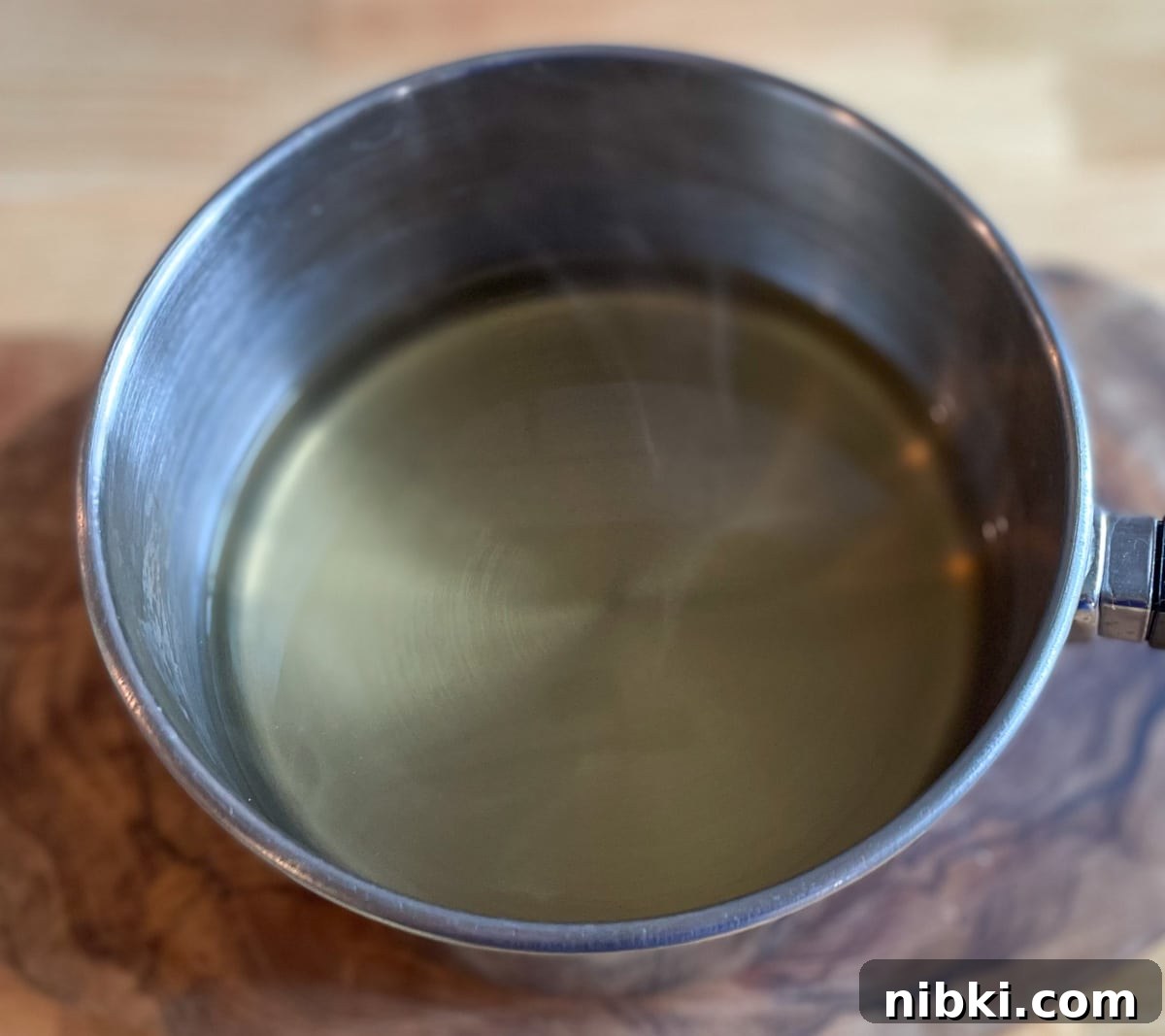 Quick Pickled White Onions for Tacos, Sandwiches and Salads 5 Pickling brine is warmed in a stainless steel pot.