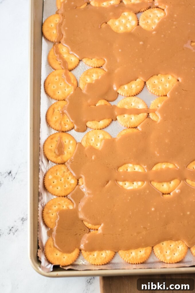 Christmas Crack: Saltine Toffee with Chocolate and Pecans 3 Crackers on a sheet pan