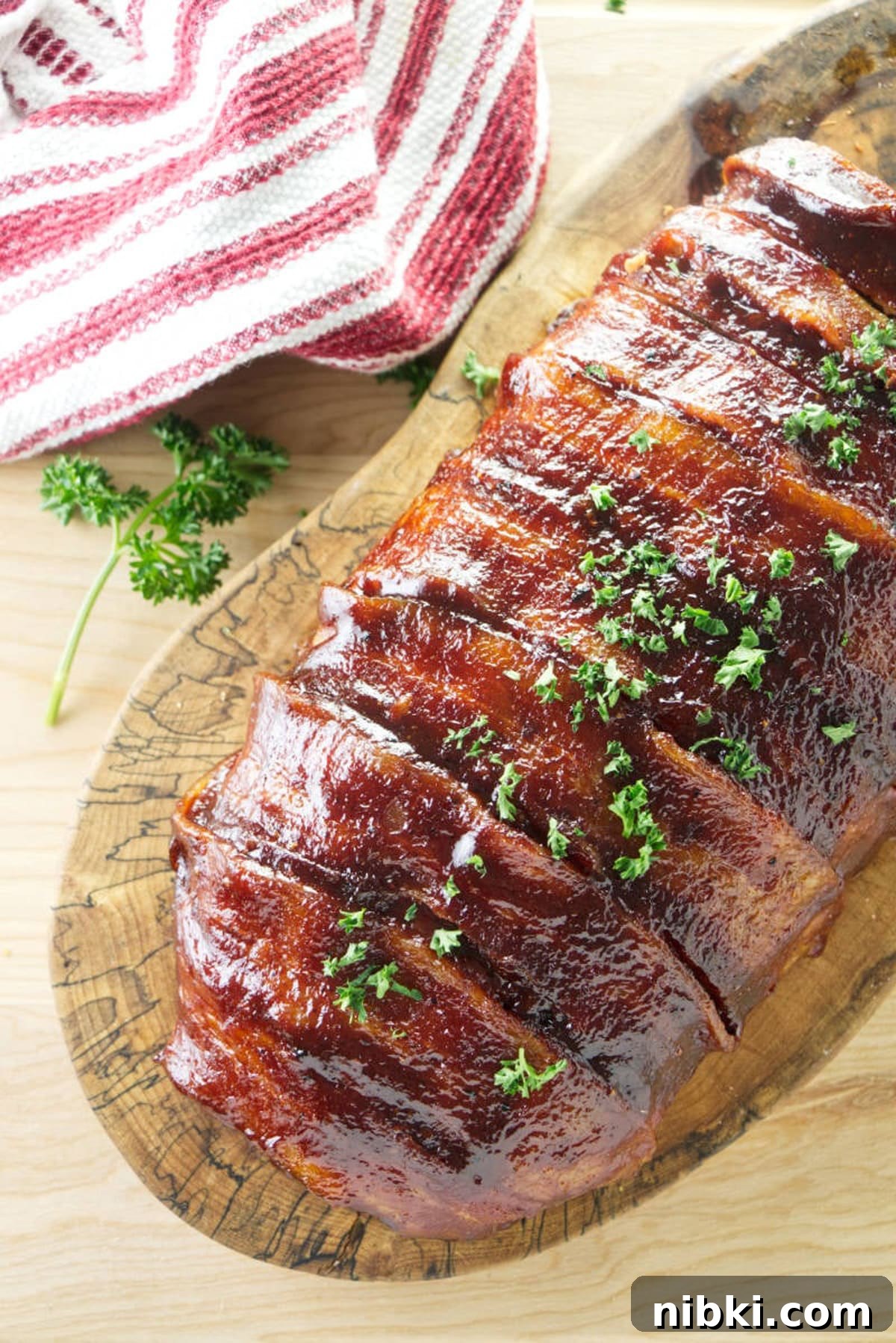 Smoked Meatloaf Recipe with Brown Sugar Glaze 13 Sliced smoked meatloaf on a cutting board.