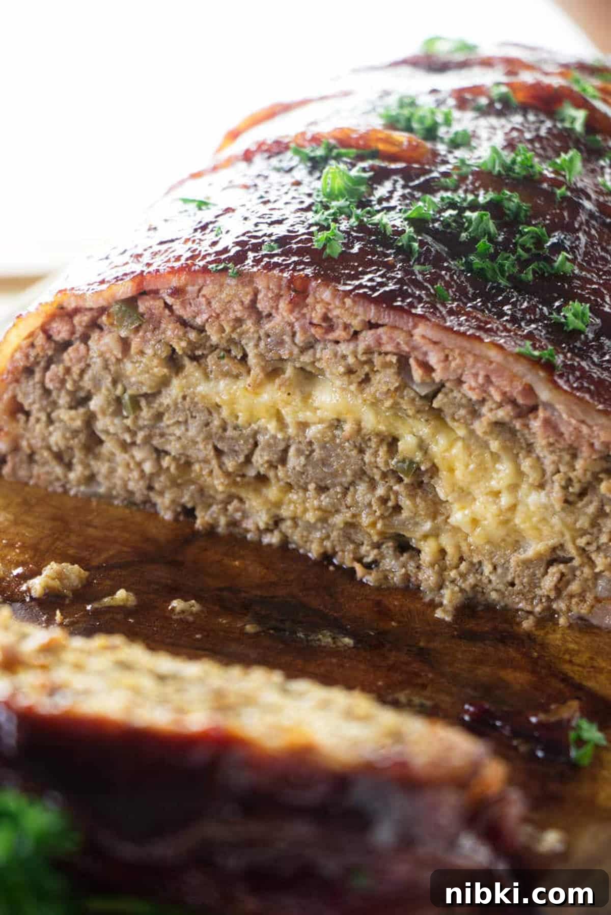 Smoked Meatloaf Recipe with Brown Sugar Glaze 3 Cheese stuffed smoked meatloaf being served.