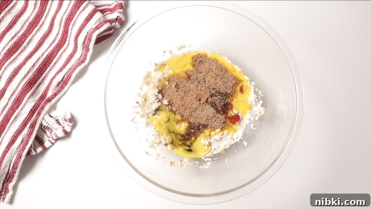 Smoked Meatloaf Recipe with Brown Sugar Glaze 7 Bowl of meatloaf ingredients on a counter.