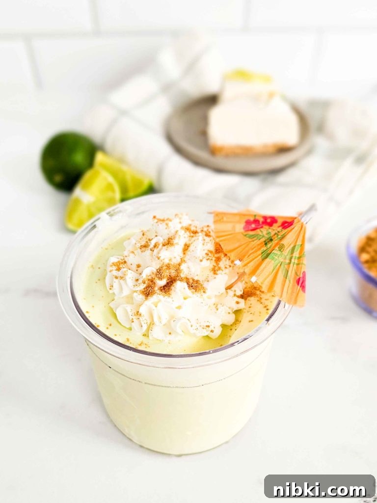 Key Lime Pie Protein Ice Cream Recipe for Ninja Creami 4 Cup of ice cream with a small umbrella