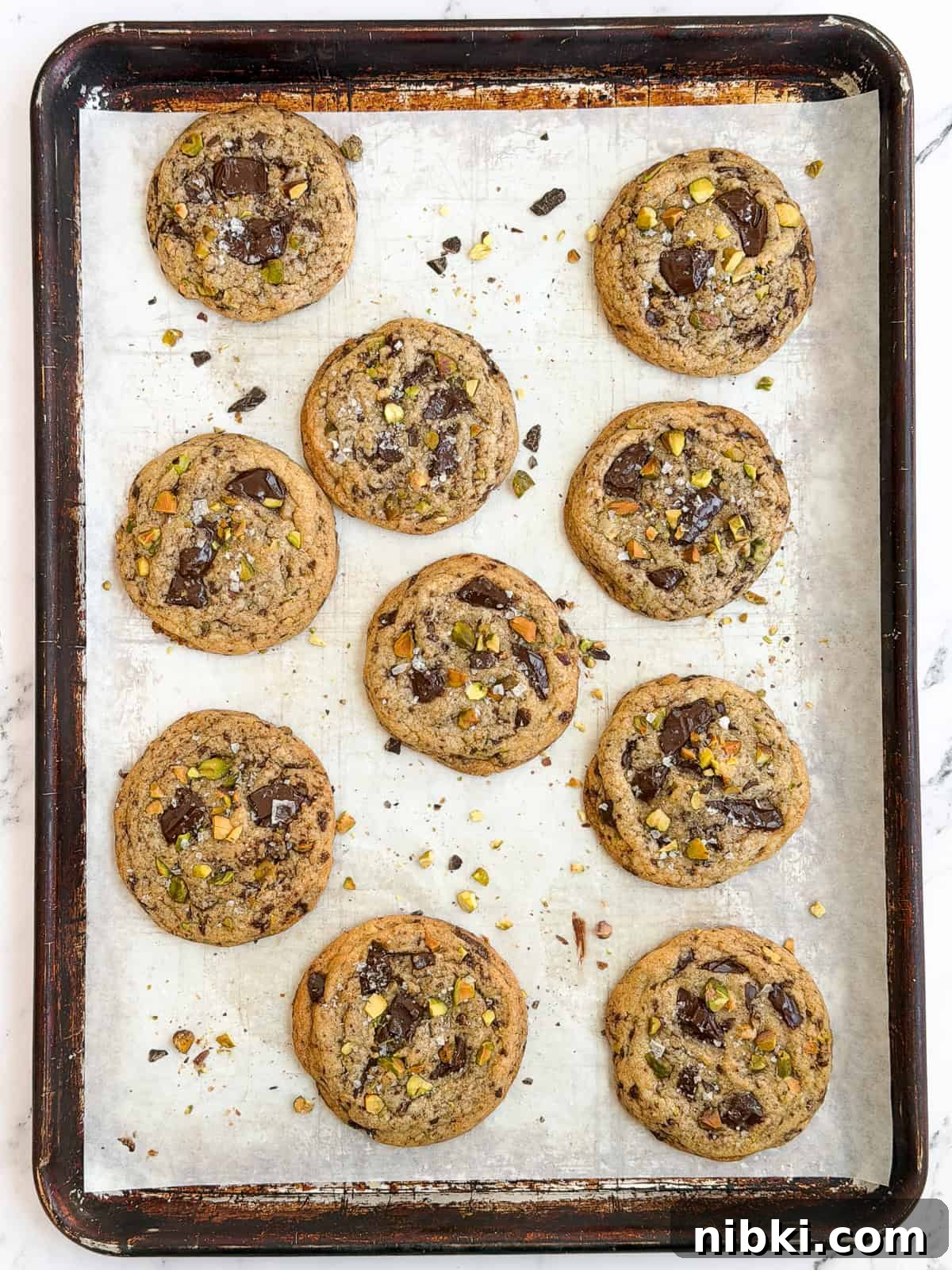 Chewy Pistachio Chocolate Chip Cookies Recipe 11 all the pistachio chocolate chip cookies on a baking sheet.