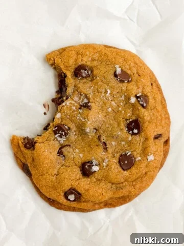 Chewy Pistachio Chocolate Chip Cookies Recipe 13 a single serve pumpkin cookie with a bite missing.