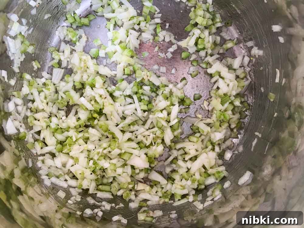Instant Pot Creamy Mushroom and Spinach Risotto 5 Finely diced onion and celery cooking in an Instant Pot.