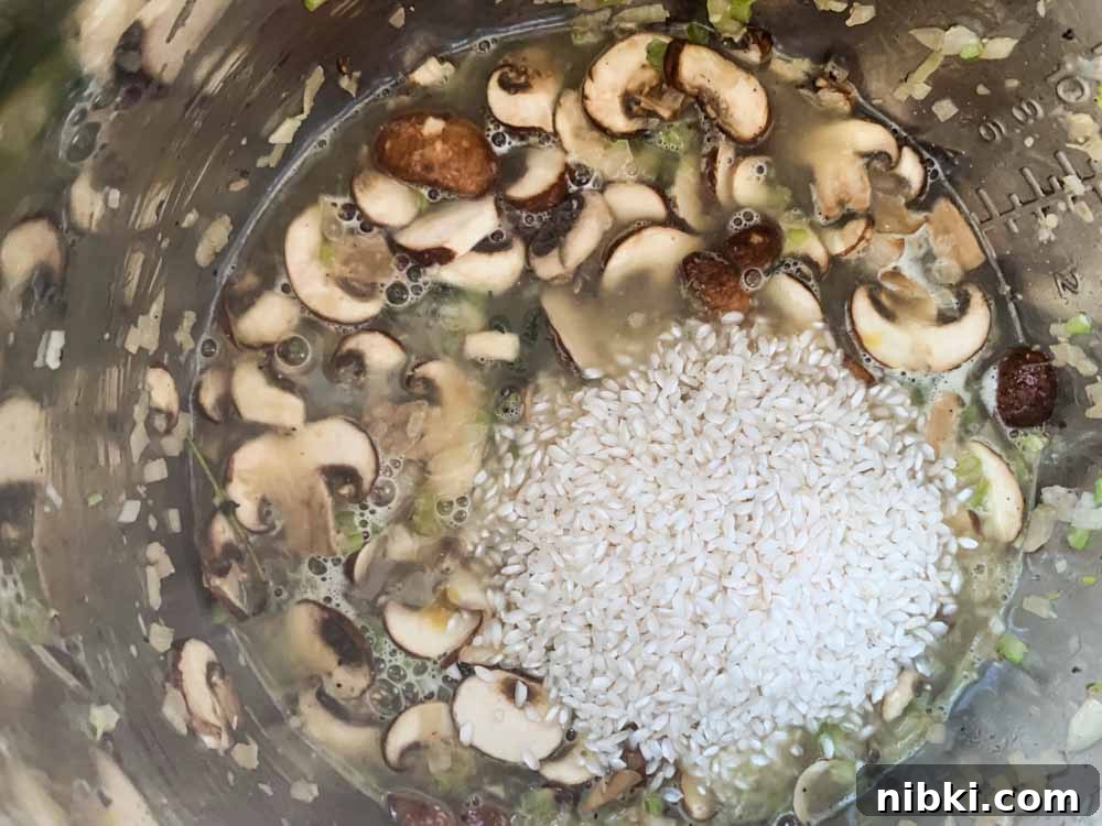 Instant Pot Creamy Mushroom and Spinach Risotto 7 All the ingredients for instant pot mushroom and spinach risotto in an Instant Pot waiting to be pressure cooked.