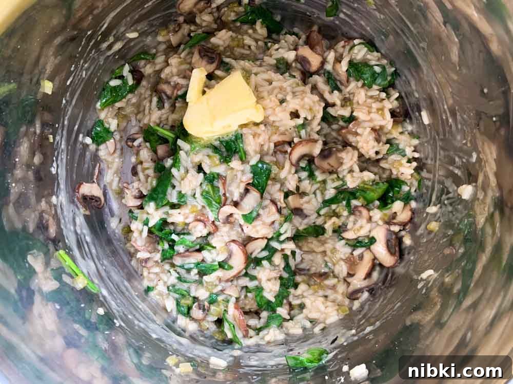 Instant Pot Creamy Mushroom and Spinach Risotto 8 finishing the risotto with butter after it has been cooked in the Instant Pot