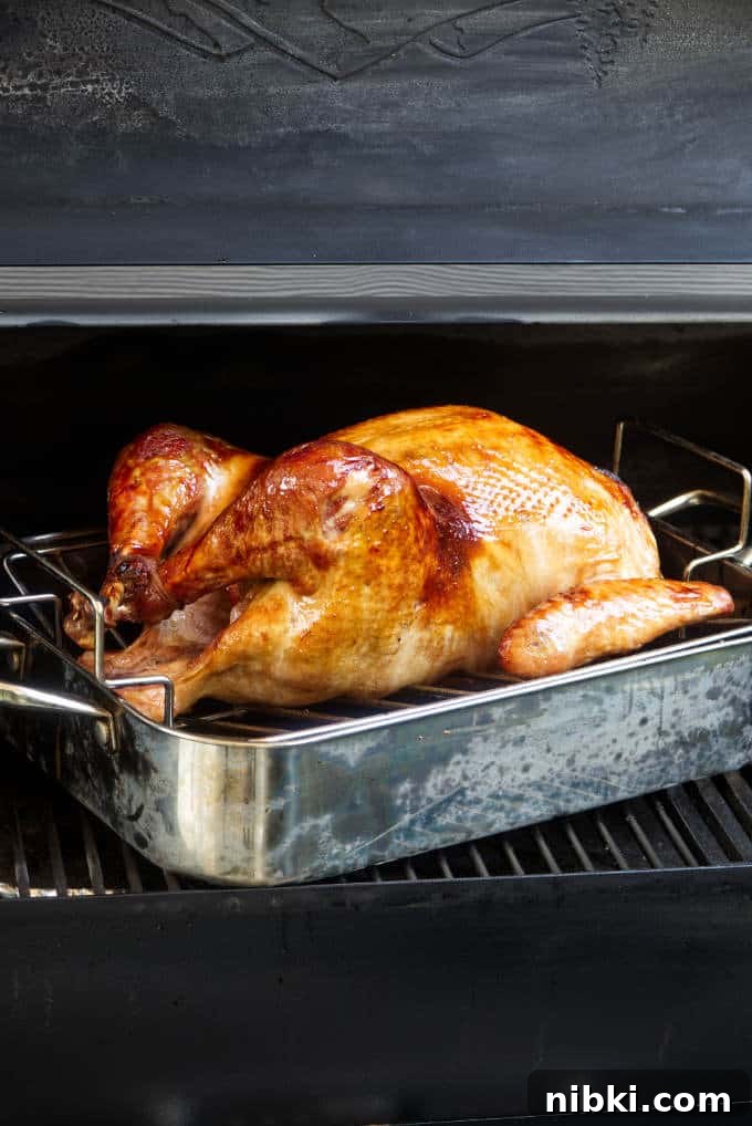 Traeger Smoked Turkey Brined with Brown Sugar and Bourbon 2 Bourbon brined and glazed turkey on a Traeger grill.