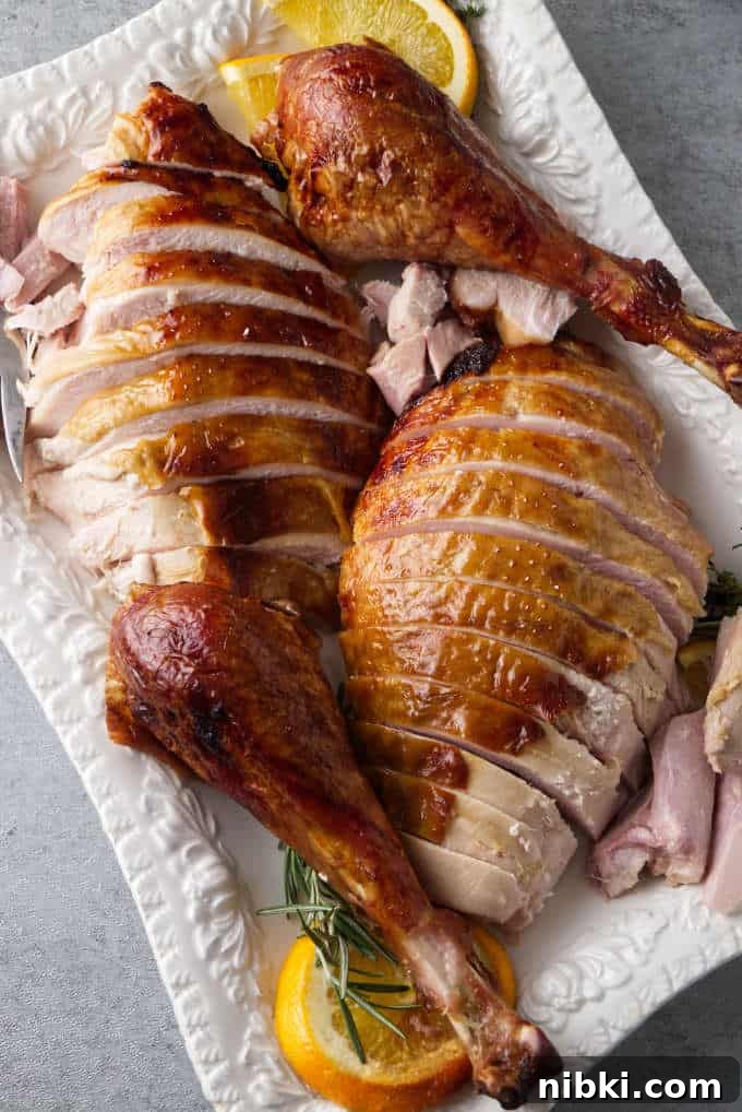 Traeger Smoked Turkey Brined with Brown Sugar and Bourbon 7 Bourbon brined Traeger turkey sliced and placed on a serving platter.