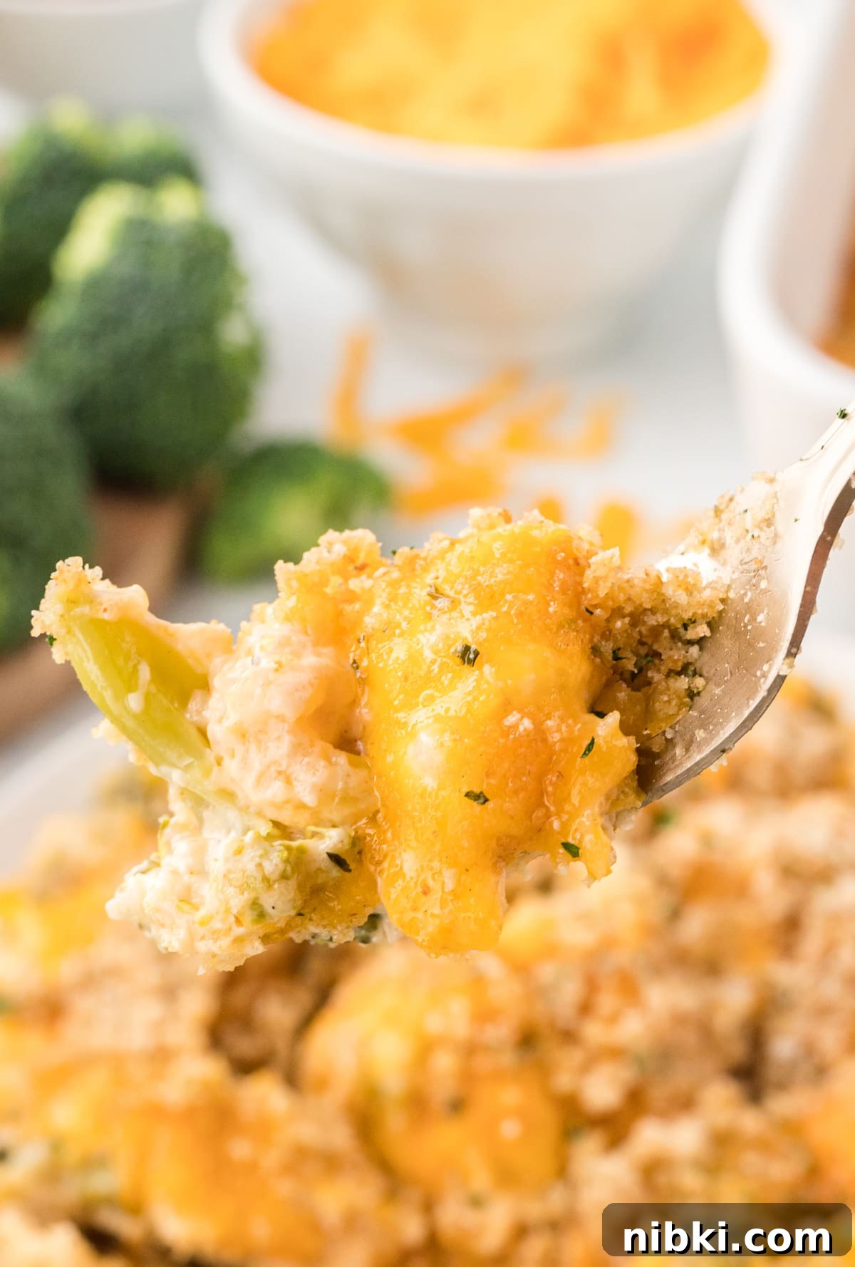 A fork of broccoli rice casserole over a plate