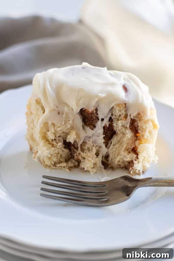 Apple Cinnamon Rolls Recipe with Brown Sugar Glaze 13 close up of apple cinnamon roll cut in half on plate