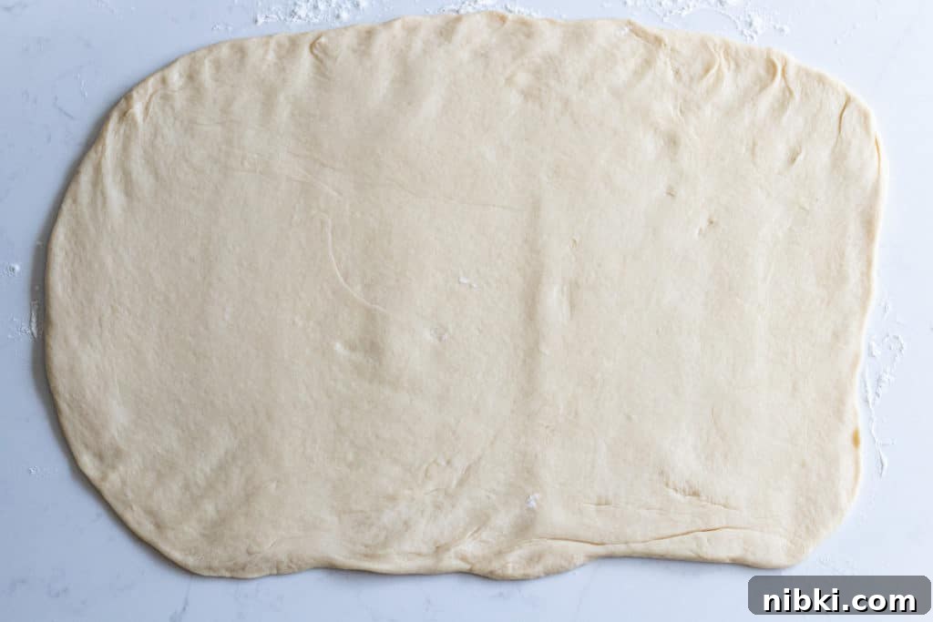 Apple Cinnamon Rolls Recipe with Brown Sugar Glaze 6 Cinnamon roll dough rolled into flat rectangle