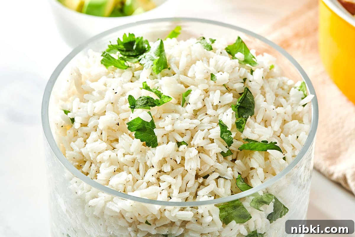How to Reheat Rice Without Drying It Out 7 Glass container of Cilantro Lime Rice.