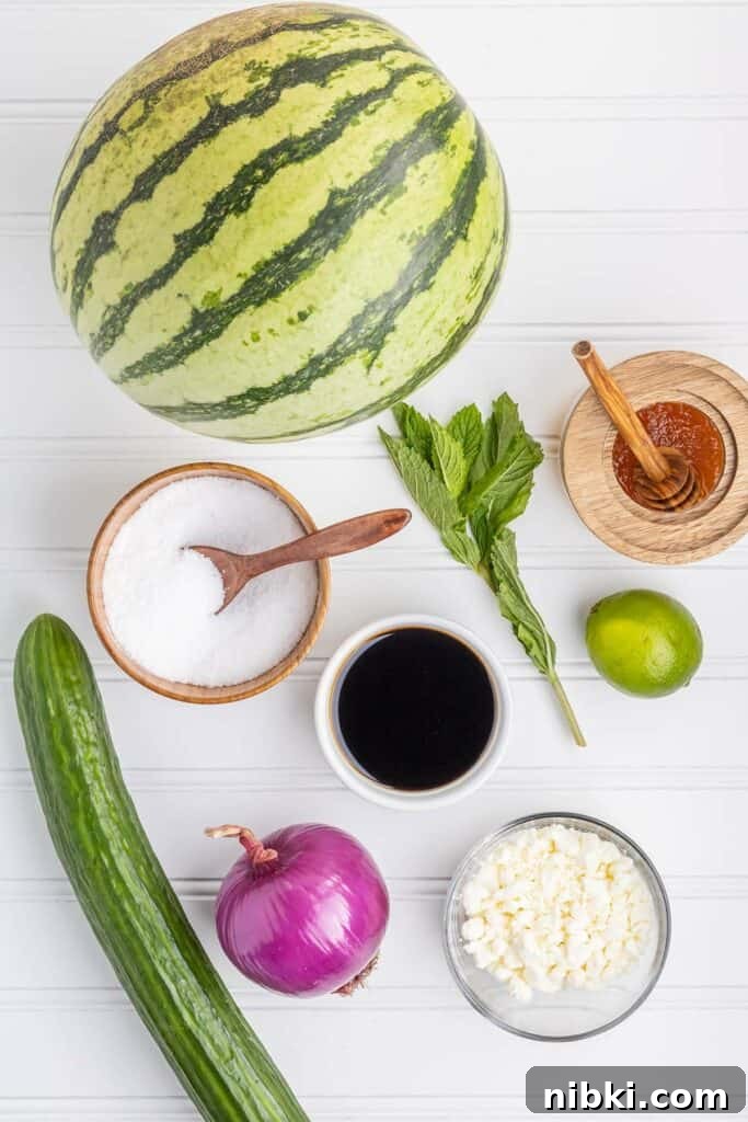 ingredients for watermelon salad on a white board
