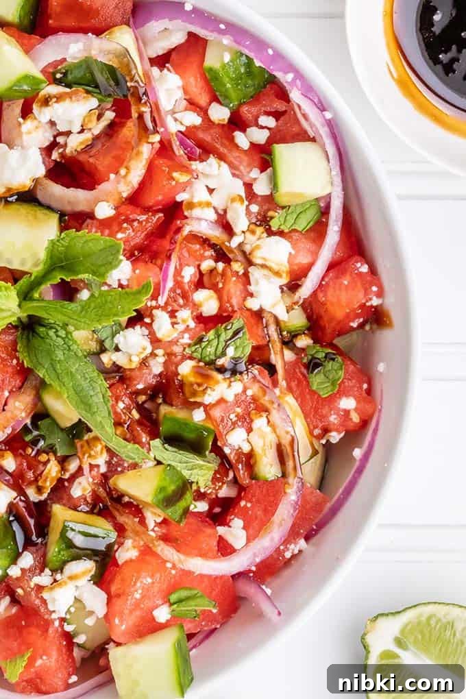close up photo of watermelon salad in a white bowl